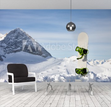 Picture of Snowboard in snow slope on a beautiful mountain background